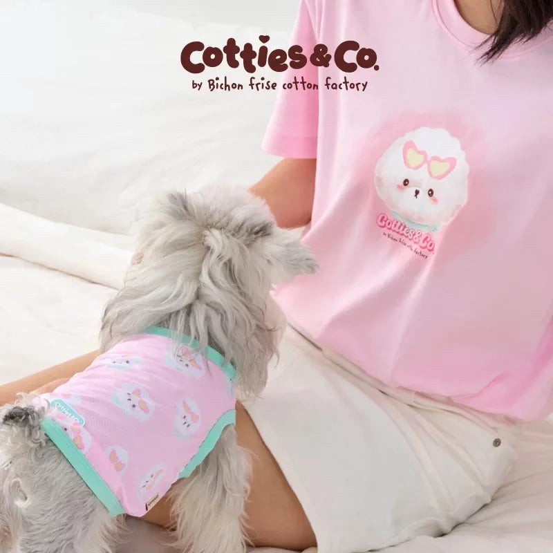 A small dog wearing size extra small of  Cotties and co cooling sleeveless shirt in pink with a bichon frise print