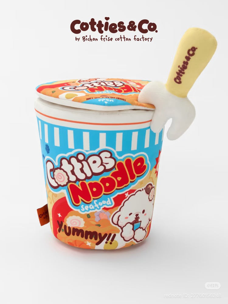 Cotties Noodle plush toy shaped like a cup of instant ramen, featuring a blue and white striped container with colorful cartoon graphics, a yellow spoon handle labeled Cotties & Co, and a matching lid. The brand text 'Cotties & Co by Bishan frise cotton factory' is visible at the top.