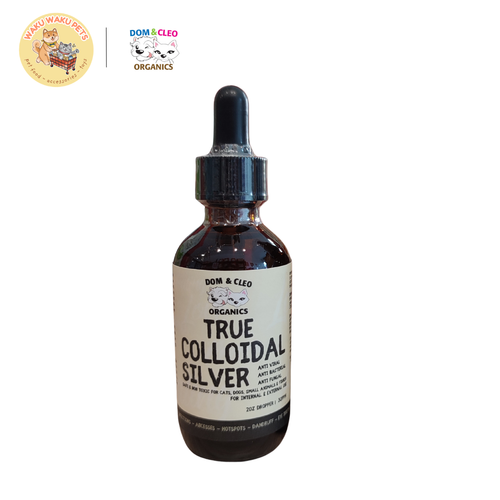 Bottle of true colloidal silver with a dropper on a white background, featuring Dom & Cleo Organics branding.
