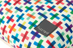 A close-up of a fuzzyard dog bed colorful geometric patterned fabric with a black brand patch reading 'FuzzYard'.