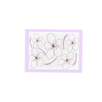 Pee pad with Flower-shaped stickers with a purple border on a white background